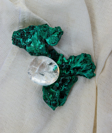 Malachite and quartz crystal on cloth.